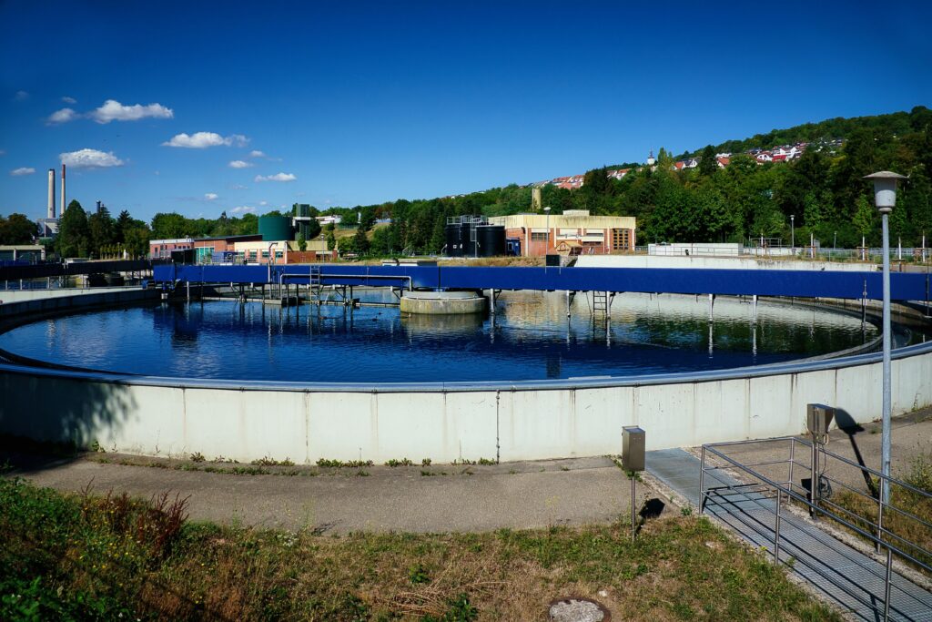 A modern wastewater treatment facility with sedimentation basin under blue sky in Pforzheim, Germany